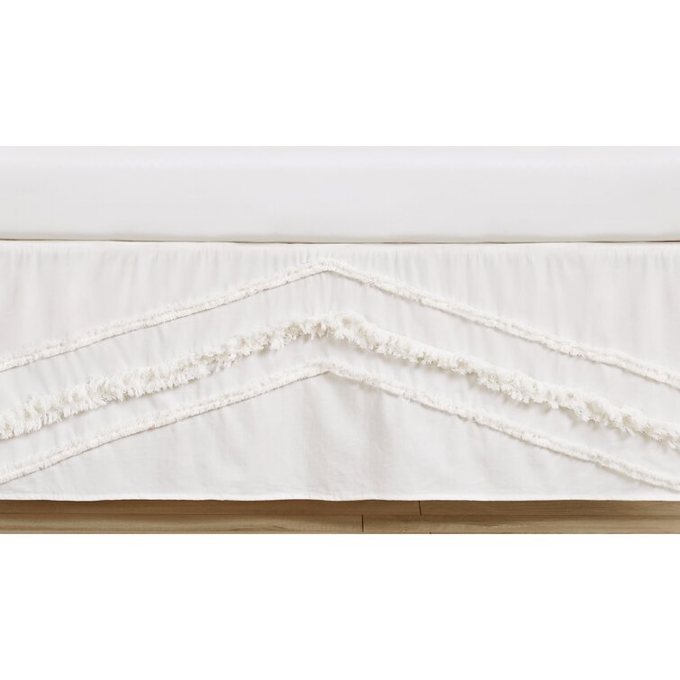 Crib skirt with outlet tassels